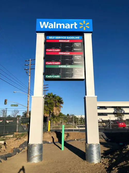 A Walmart sign board at a gas station