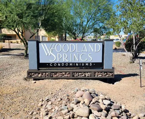 Woodland Monument sign board with rocks